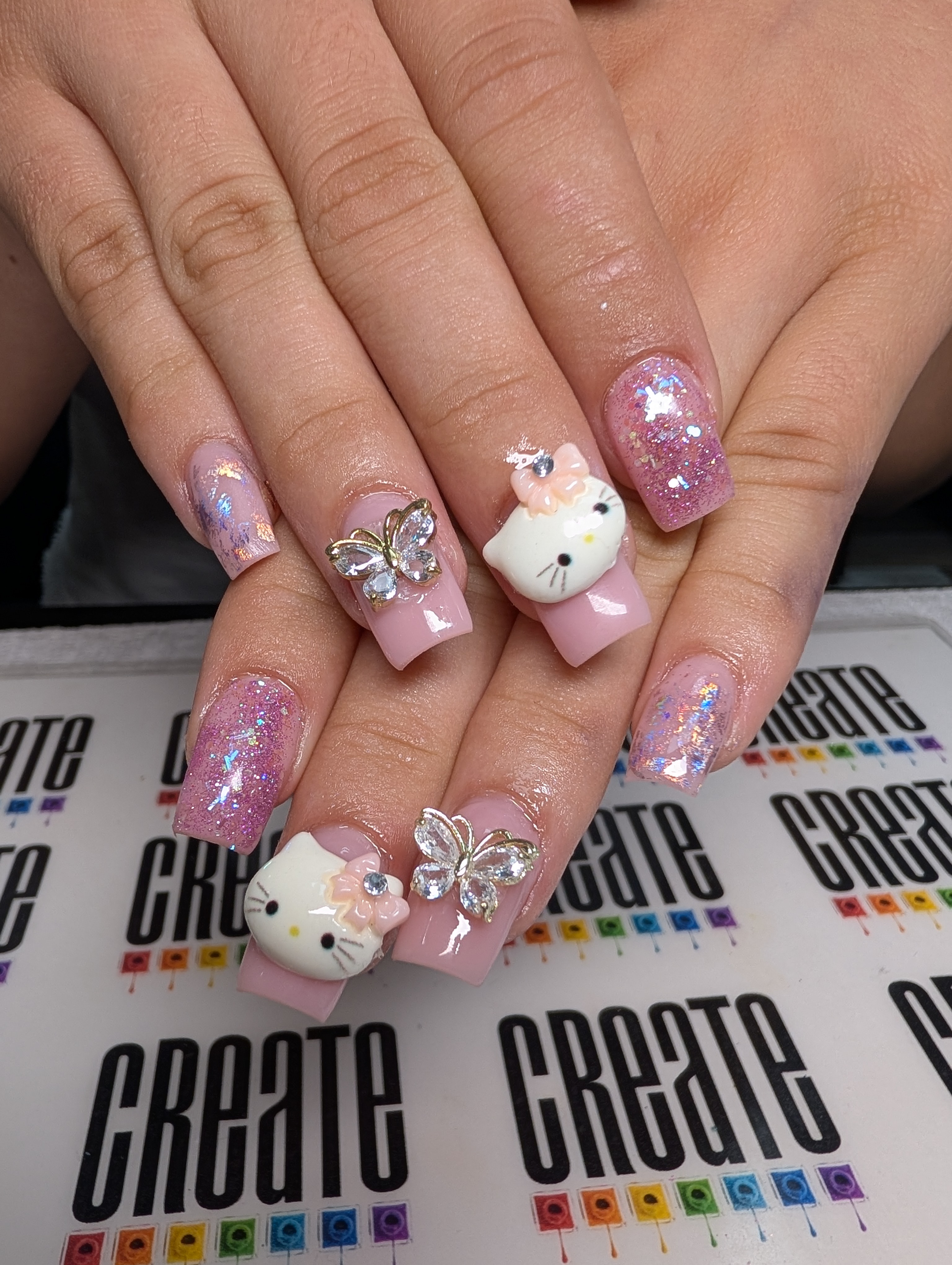 Square nails with charms.